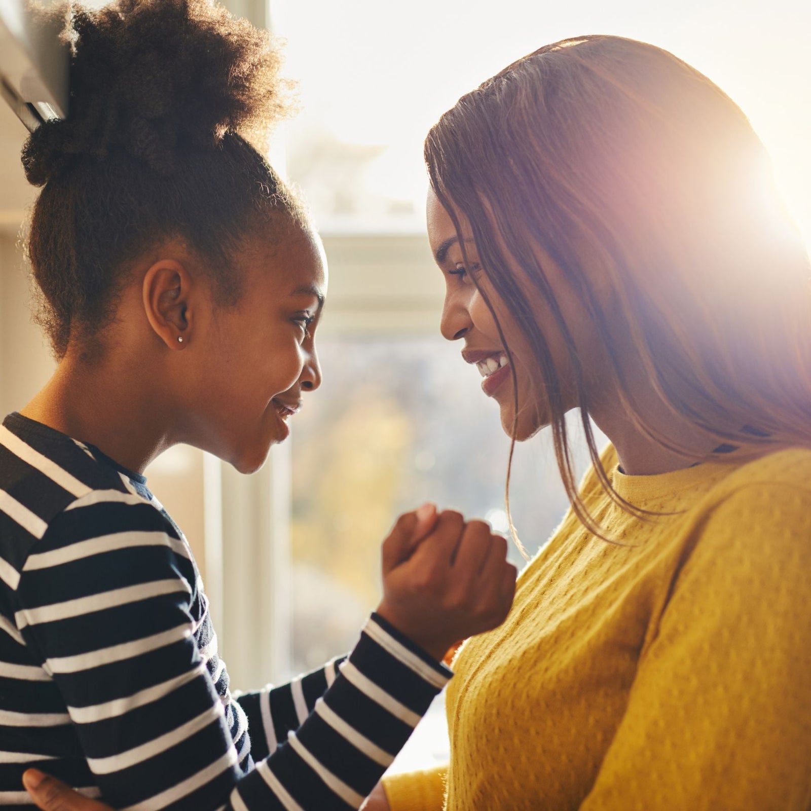 mom and daughter facing each other and looking into each other's eyes