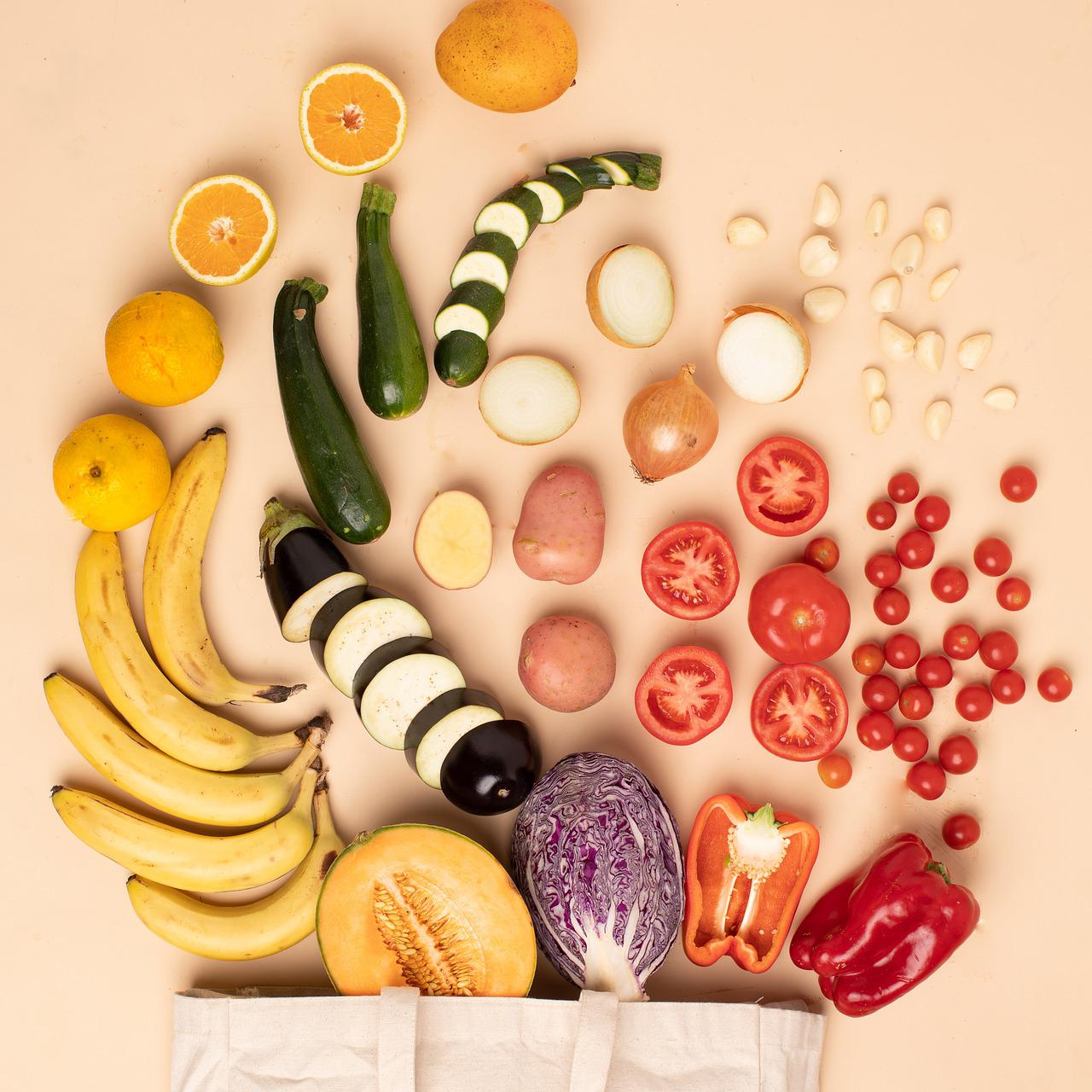 produce cut up and artfully arranged in a swirl coming out of a reusable bag