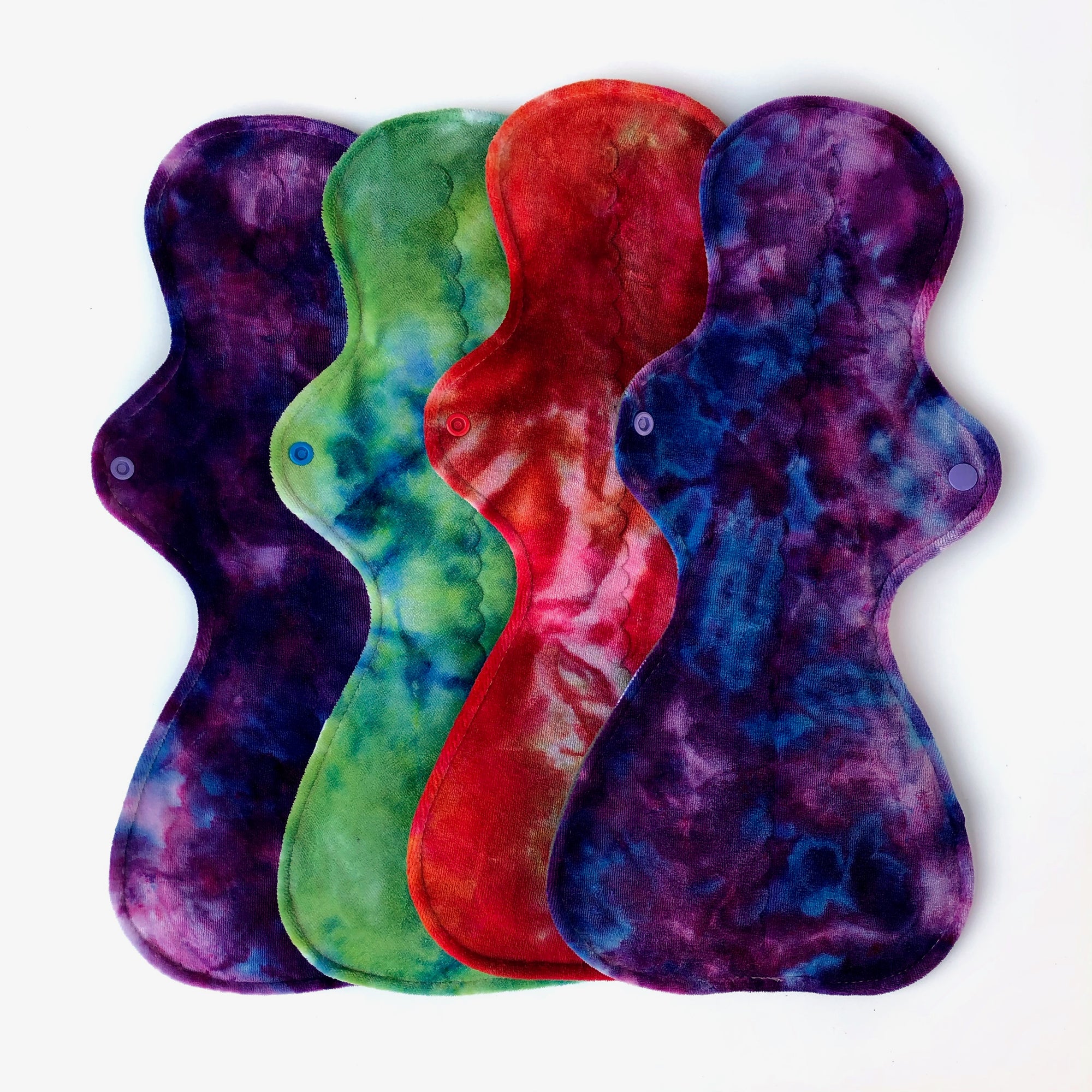 four reusable postpartum pads in bright colours