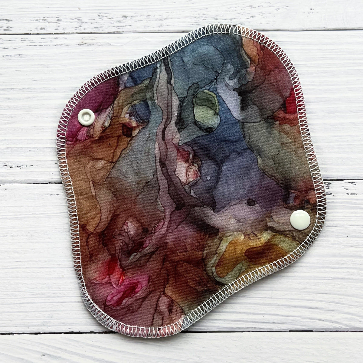 reusable liner in an earthy and jewel toned alcohol ink print