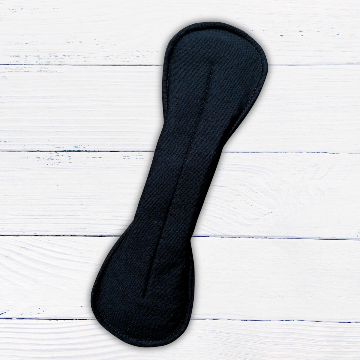 amie active black extra-long reusable pad snapped on a rustic white wood background