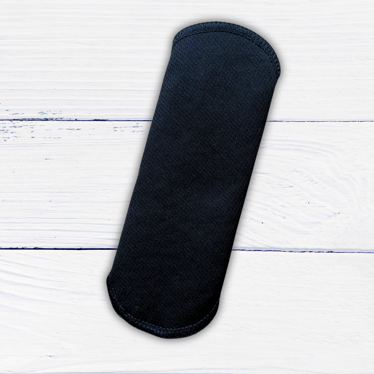 amie active reusable liner snapped closed on rustic white wood background