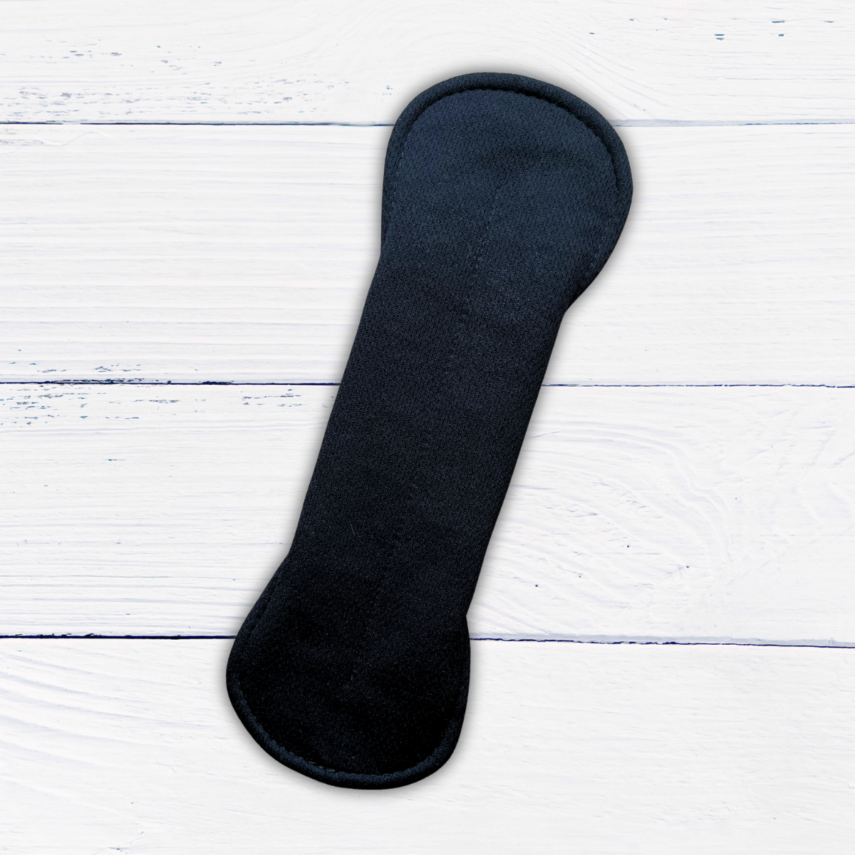 amie active black standard length reusable pad snapped on a rustic white wood background
