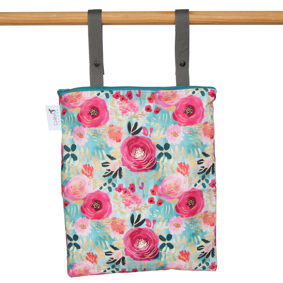 Floral-patterned bag hanging on a wooden rod with a white background