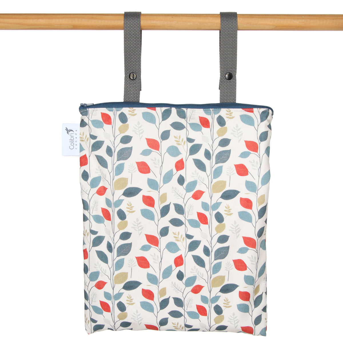 Patterned bag with leaf design hanging on a wooden rod