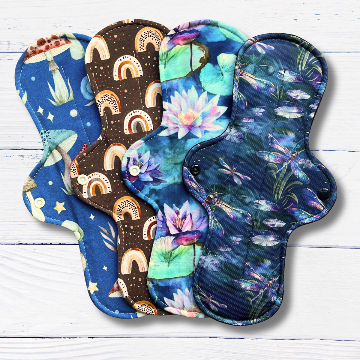Set of colourful reusable menstrual or incontinence pads on a wooden surface