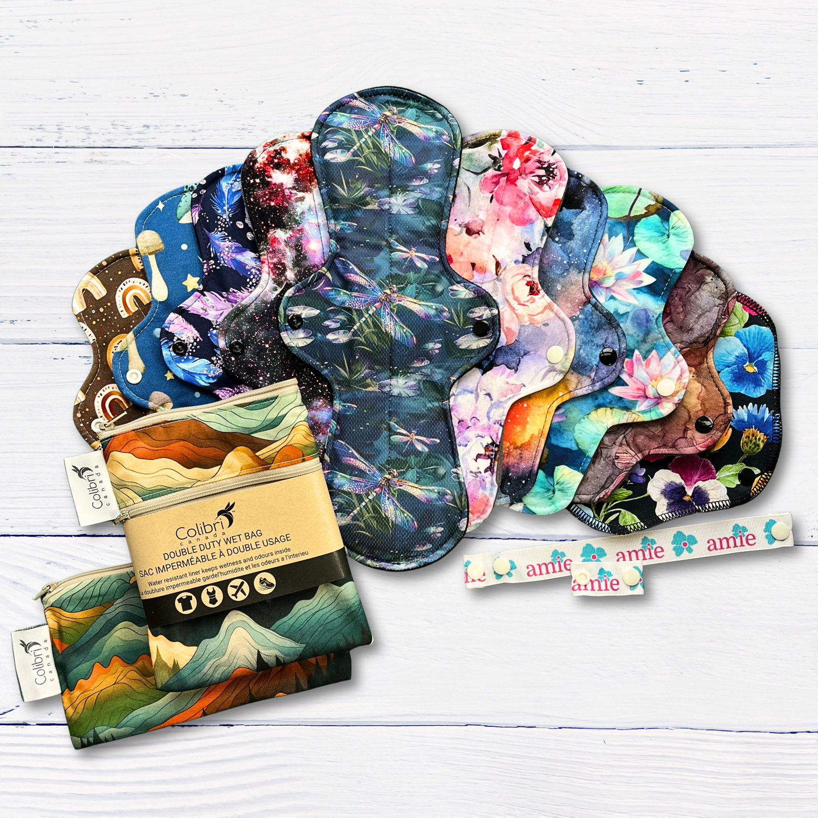 complete set of colourful reusable pads for periods with accessories on a white wood background