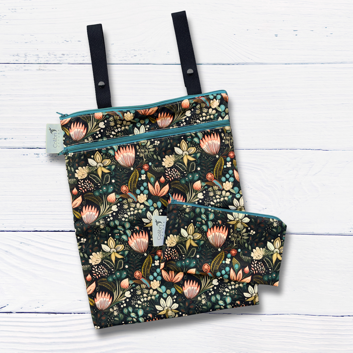 Floral-patterned wet bags with zippers on a white wooden surface