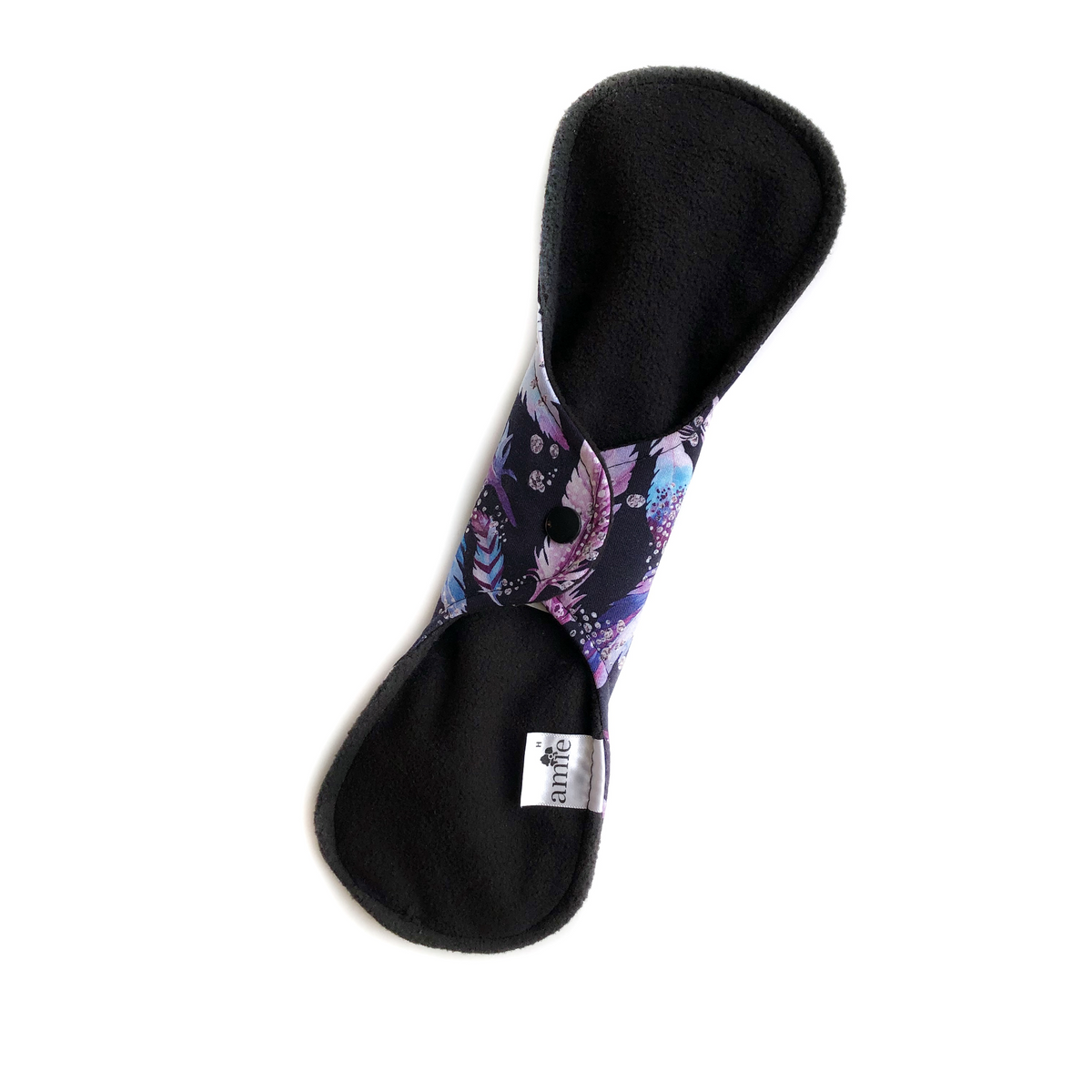 Sample back of an Amie reusable pad showing wings folded behind the pad and snapped closed and placement of label