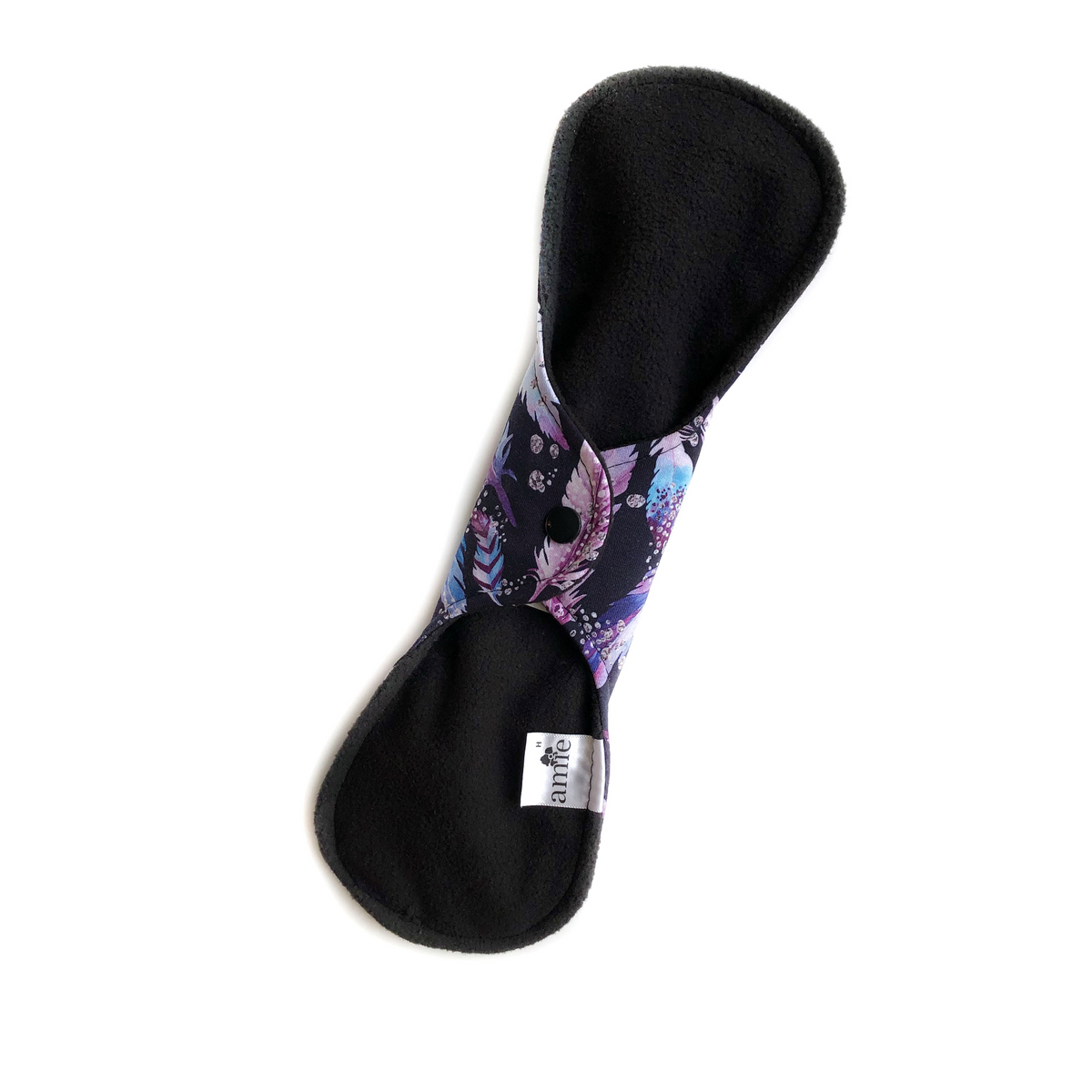 back of a closed reusable pad or washable incontinence pad black fuzzy soft shell and a purple feathers print