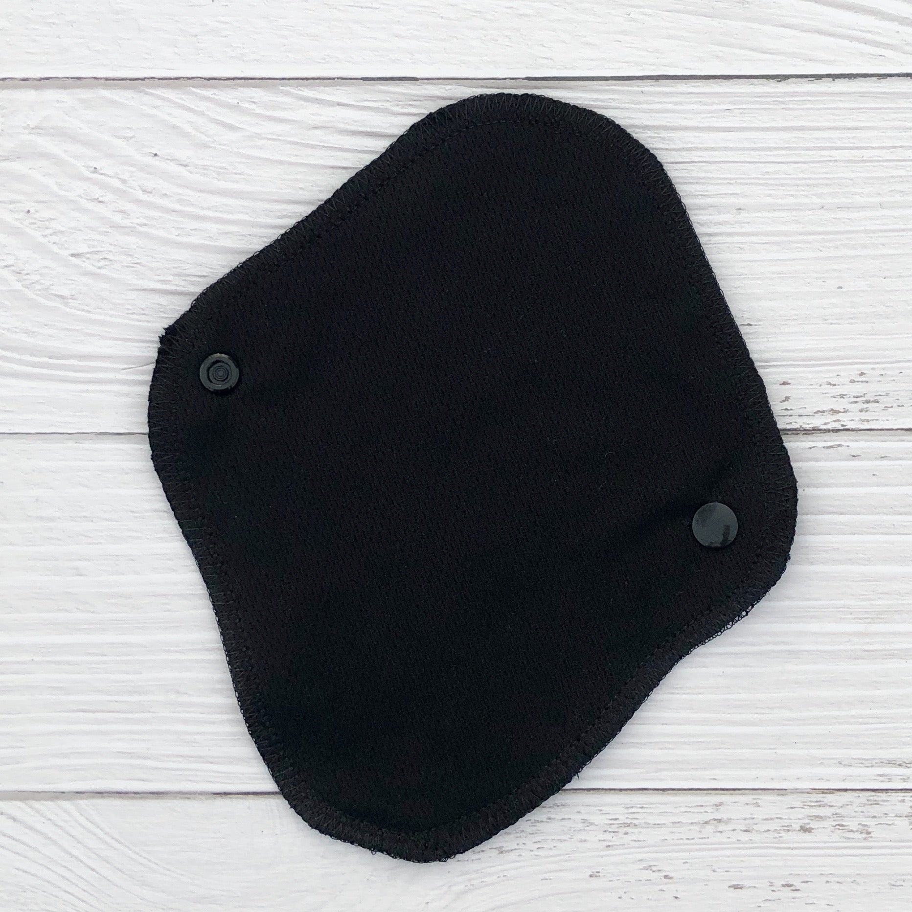 reusable pantyliner in black athletic wicking jersey