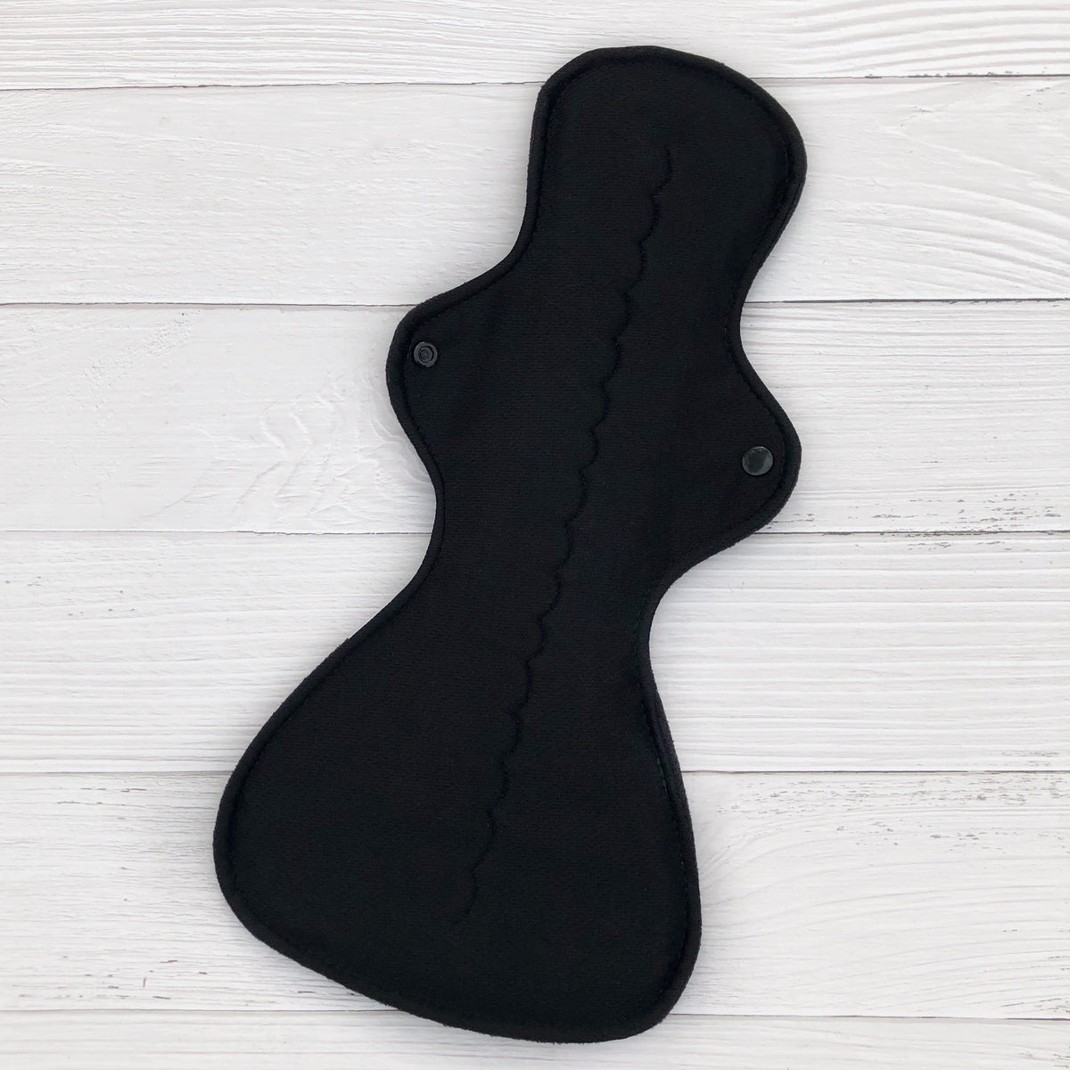 super absorbency reusable pad topped with black athletic wicking jersey